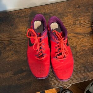 Bright coral and purple Nike sneakers